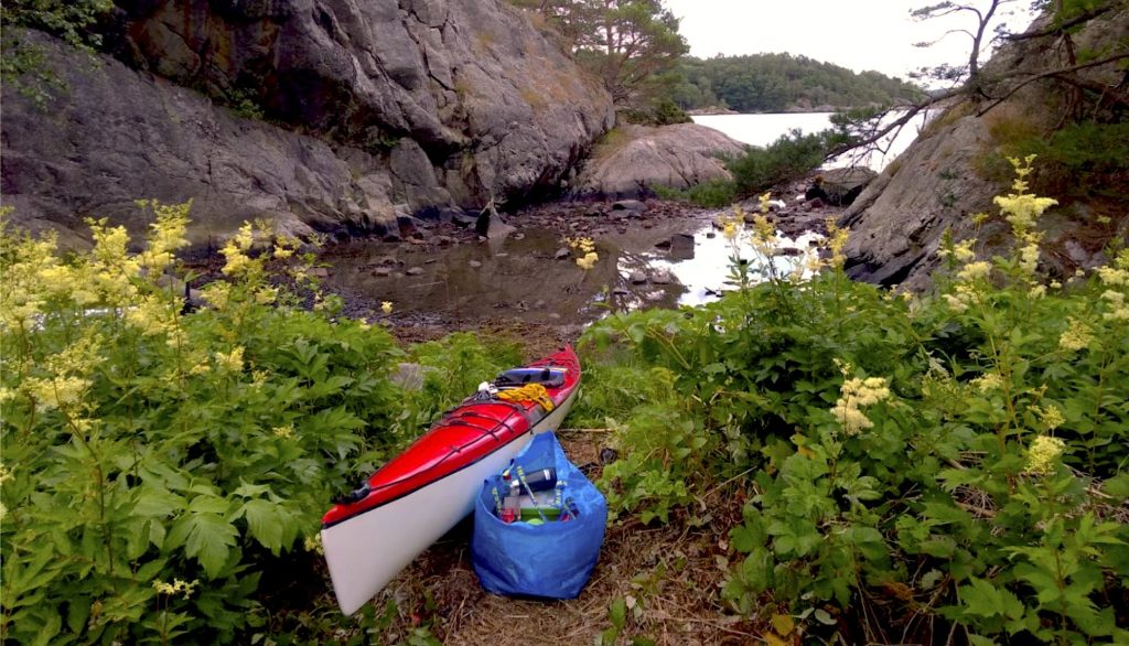 Havkajak på en søbrd med oppakning